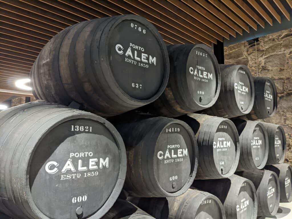 barrels stacked on top of eachother of port wine at Calem Wines in Porto, Portugal